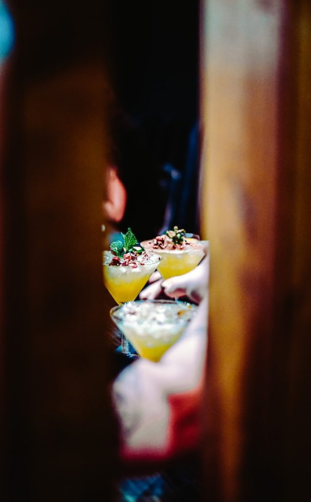 two cocktails seen through a doorway