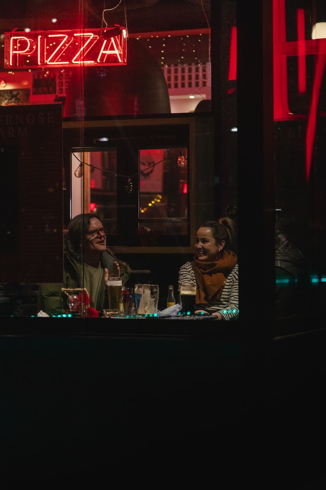 two people eating at a restaurant at night