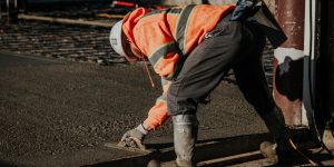 road laying construction worker laying tarmac and asphalt