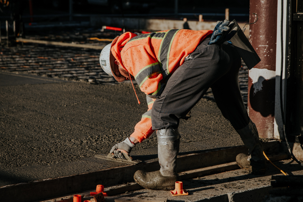 road laying construction worker laying tarmac and asphalt